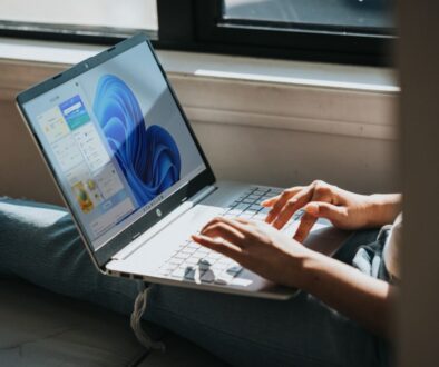 person using Windows 11 computer on lap