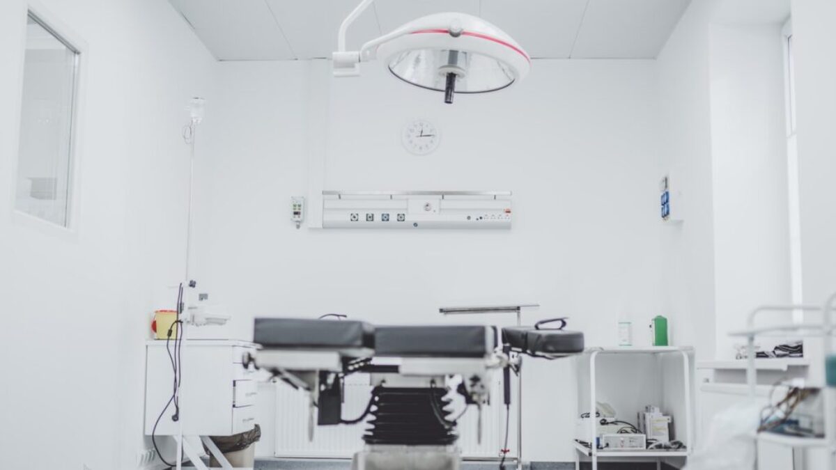 black and white hospital bed in the middle of interior building