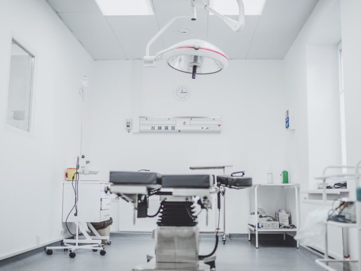 black and white hospital bed in the middle of interior building
