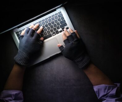 person in black long sleeve shirt using macbook pro