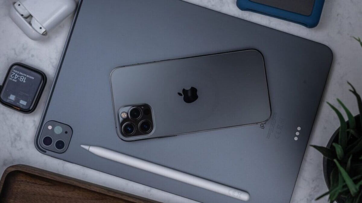 silver ipad on brown wooden table