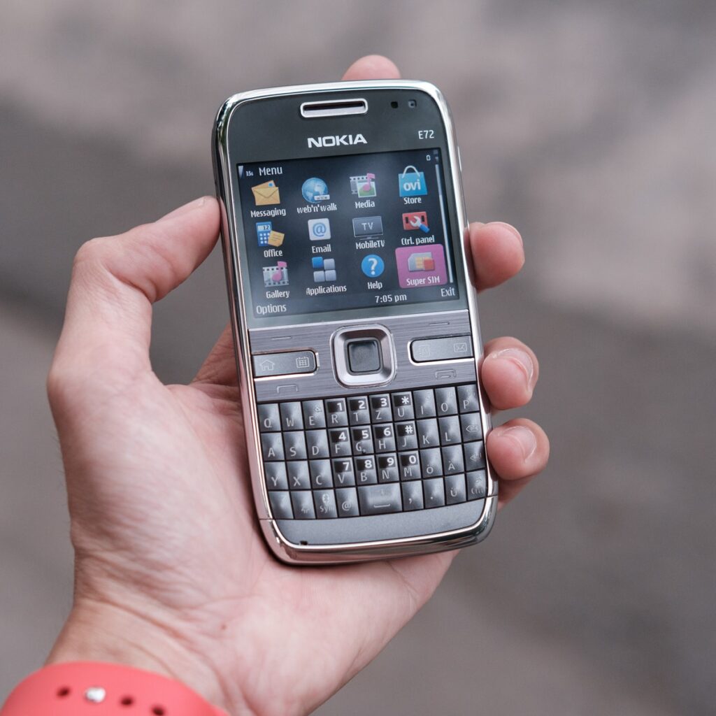 person holding gray nokia qwerty phone
