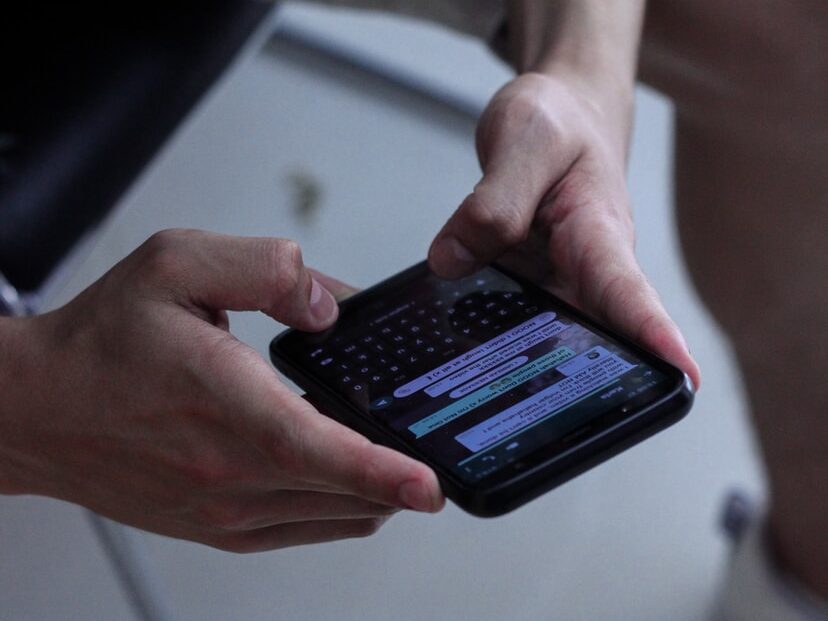 person holding black iphone 4