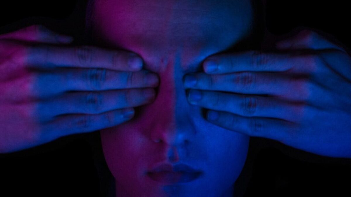 person covering his eyes wallpaper
