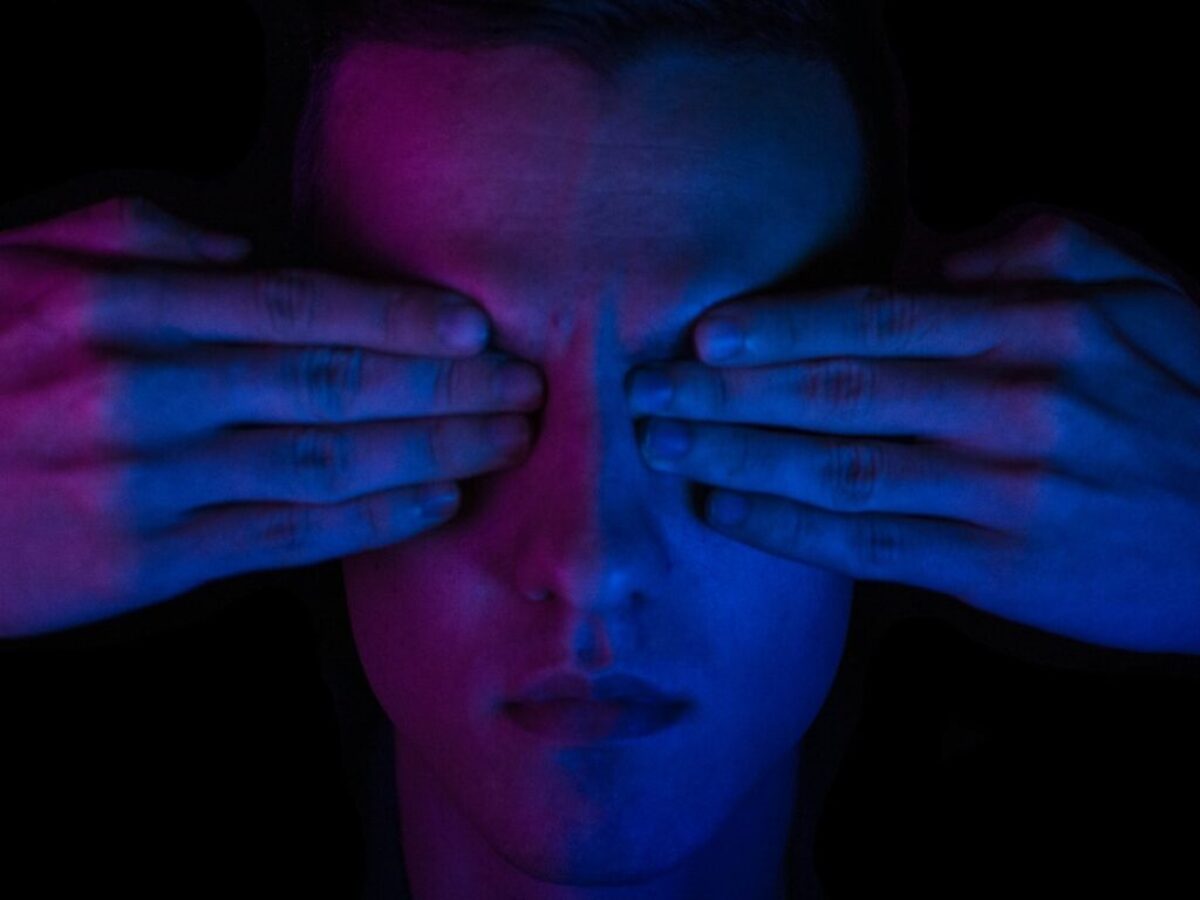 person covering his eyes wallpaper