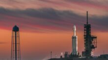 white rocket under nimbus clouds at golden hour