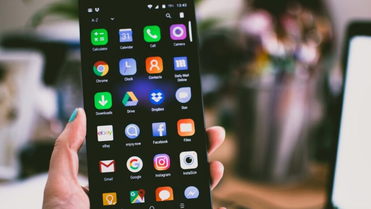 Selective Focus Photography of Person Holding Turned on Smartphone