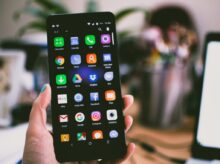 Selective Focus Photography of Person Holding Turned on Smartphone