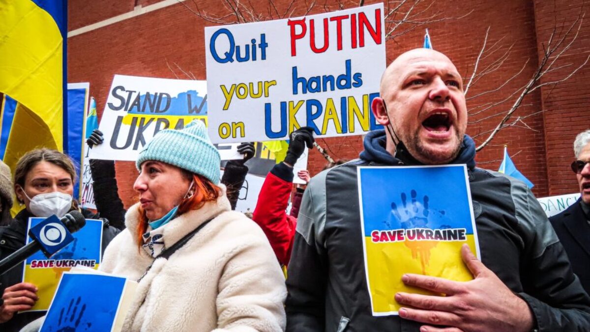 People Holding Anti-War Signs and Protesting in the Street