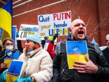 People Holding Anti-War Signs and Protesting in the Street
