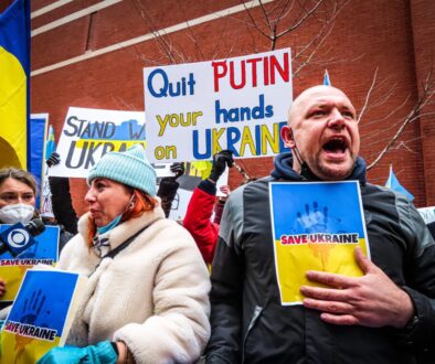 People Holding Anti-War Signs and Protesting in the Street
