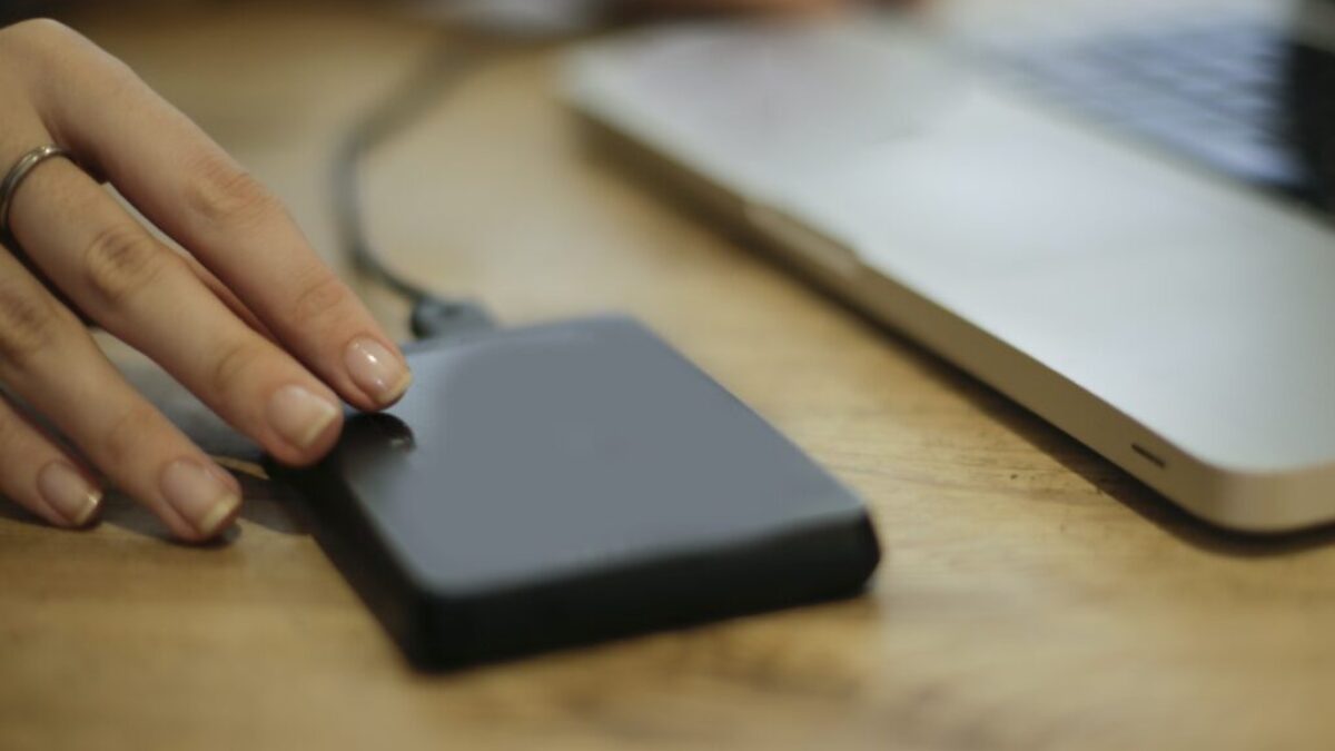 Black Square Device on Brown Wooden Table
