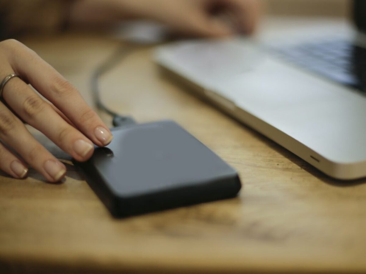 Black Square Device on Brown Wooden Table