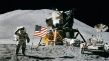 Astronaut Standing Beside American Flag on the Moon
