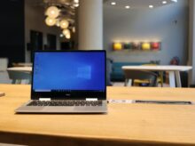 macbook pro on brown wooden table