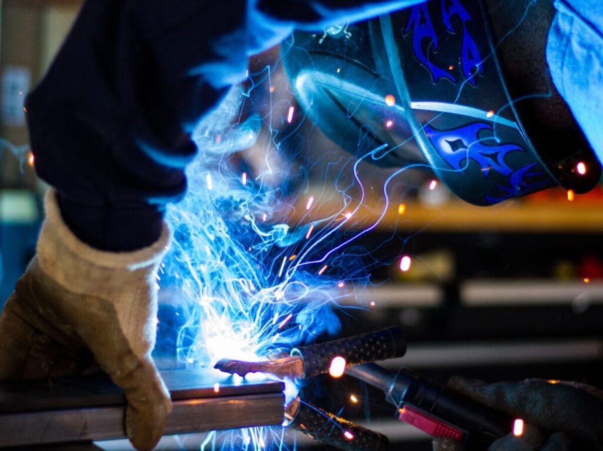 man holding gray steel frame