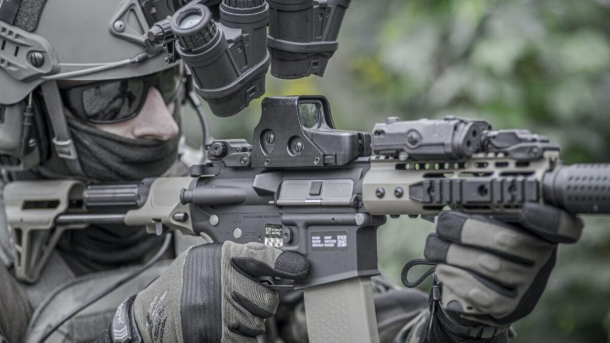 person holding grey and black rifle