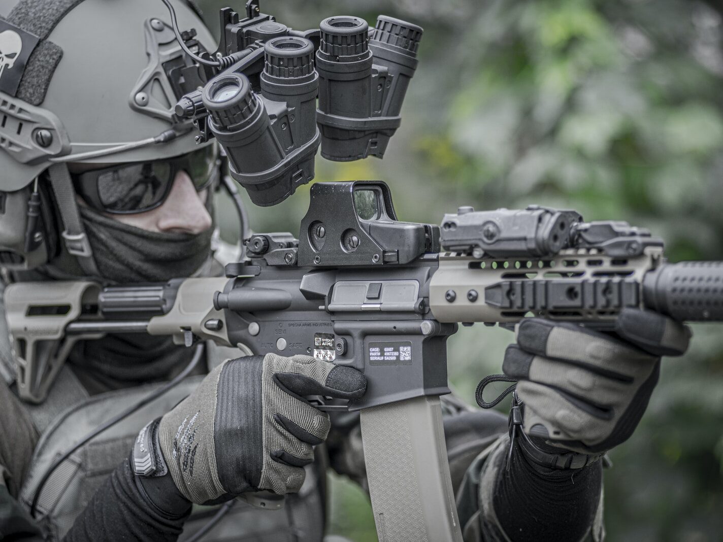 person holding grey and black rifle