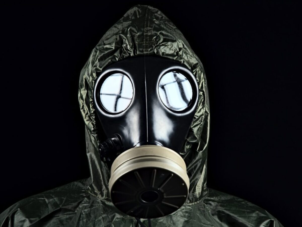 person in green and black gas mask