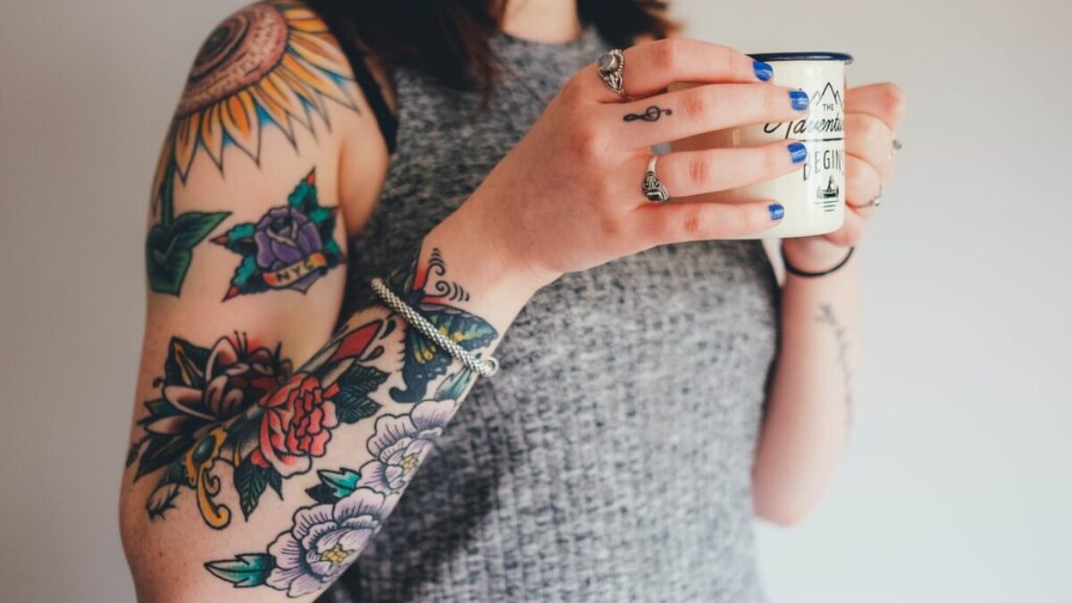 woman holding white ceramic mug