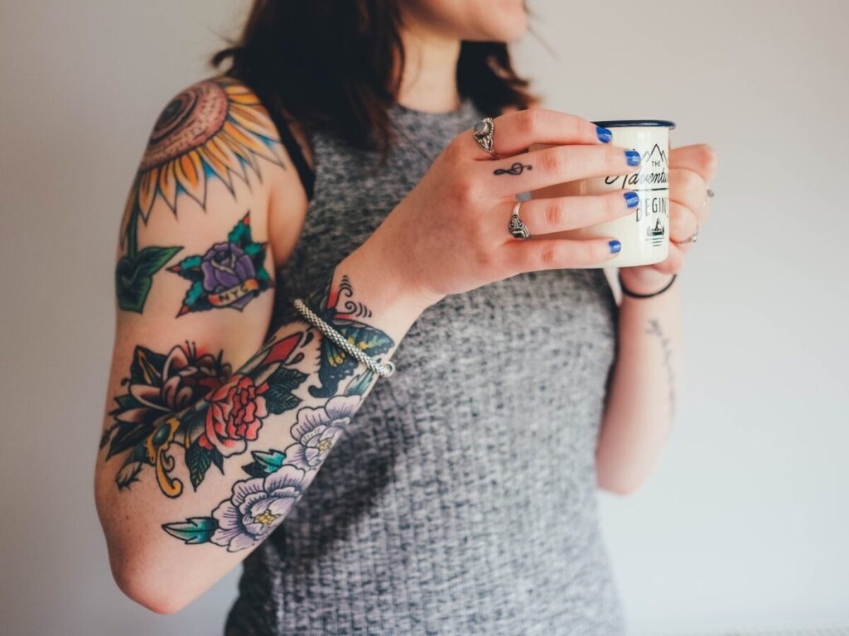 woman holding white ceramic mug