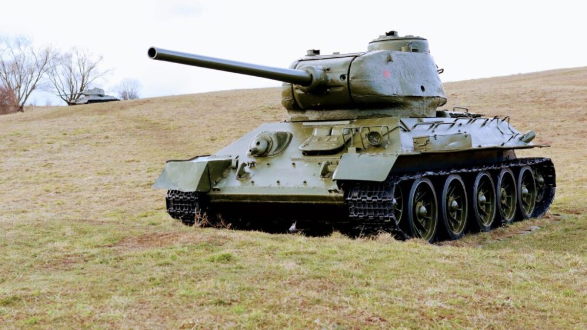 green battle tank on green grass field during daytime