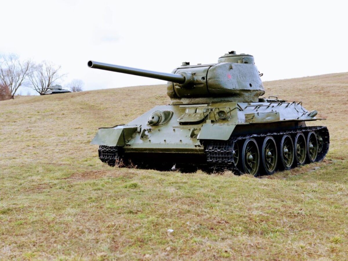 green battle tank on green grass field during daytime