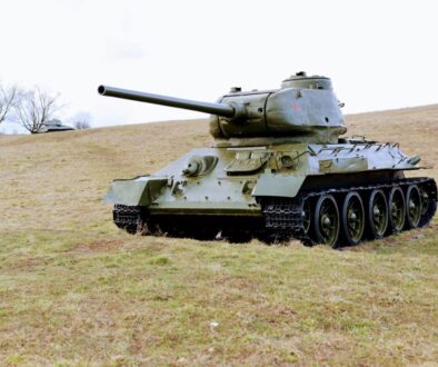 green battle tank on green grass field during daytime