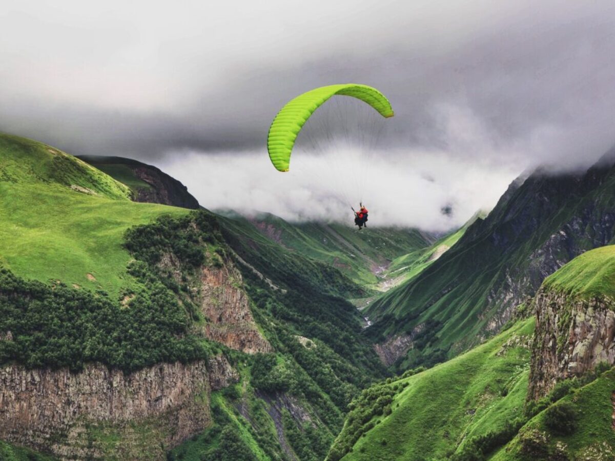 person paragliding near mountain range