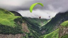 person paragliding near mountain range