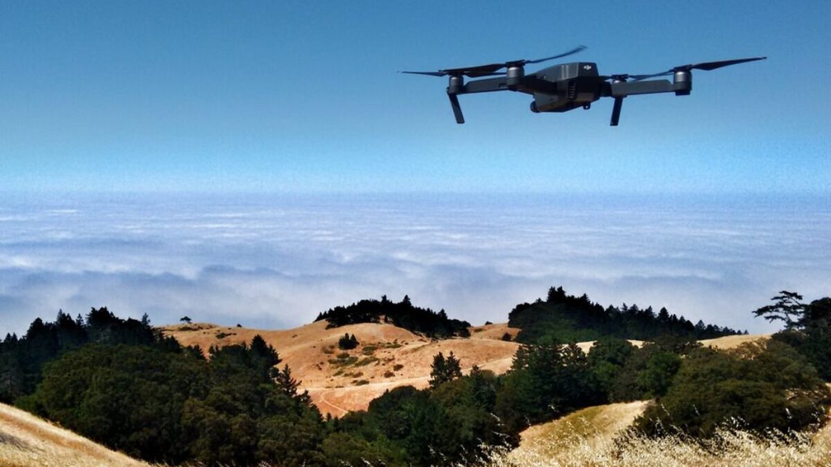 black drone on air over cloudy sky at daytime