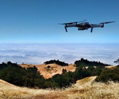 black drone on air over cloudy sky at daytime
