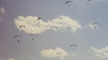 people on parachutes during daytime