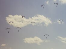 people on parachutes during daytime