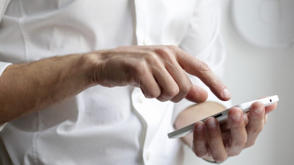 person holding white Android smartphone in white shirt