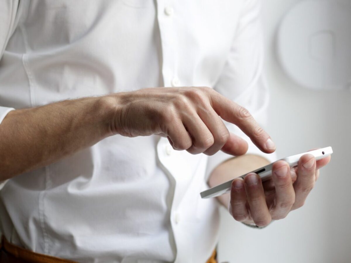 person holding white Android smartphone in white shirt