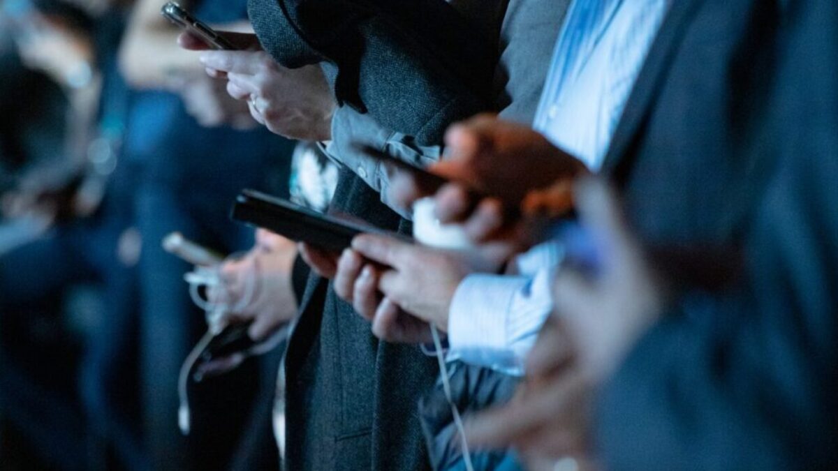 people using phone while standing