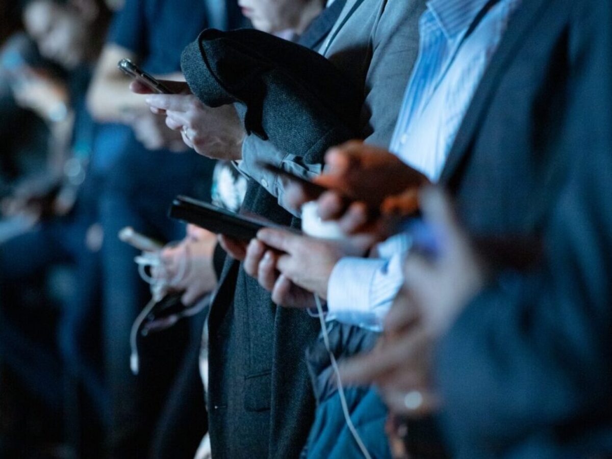 people using phone while standing