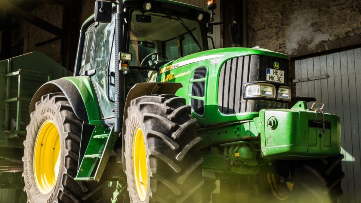 green and yellow tractor in garage