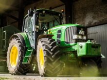 green and yellow tractor in garage