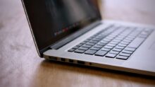 MacBook Pro on brown wooden table