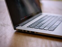 MacBook Pro on brown wooden table