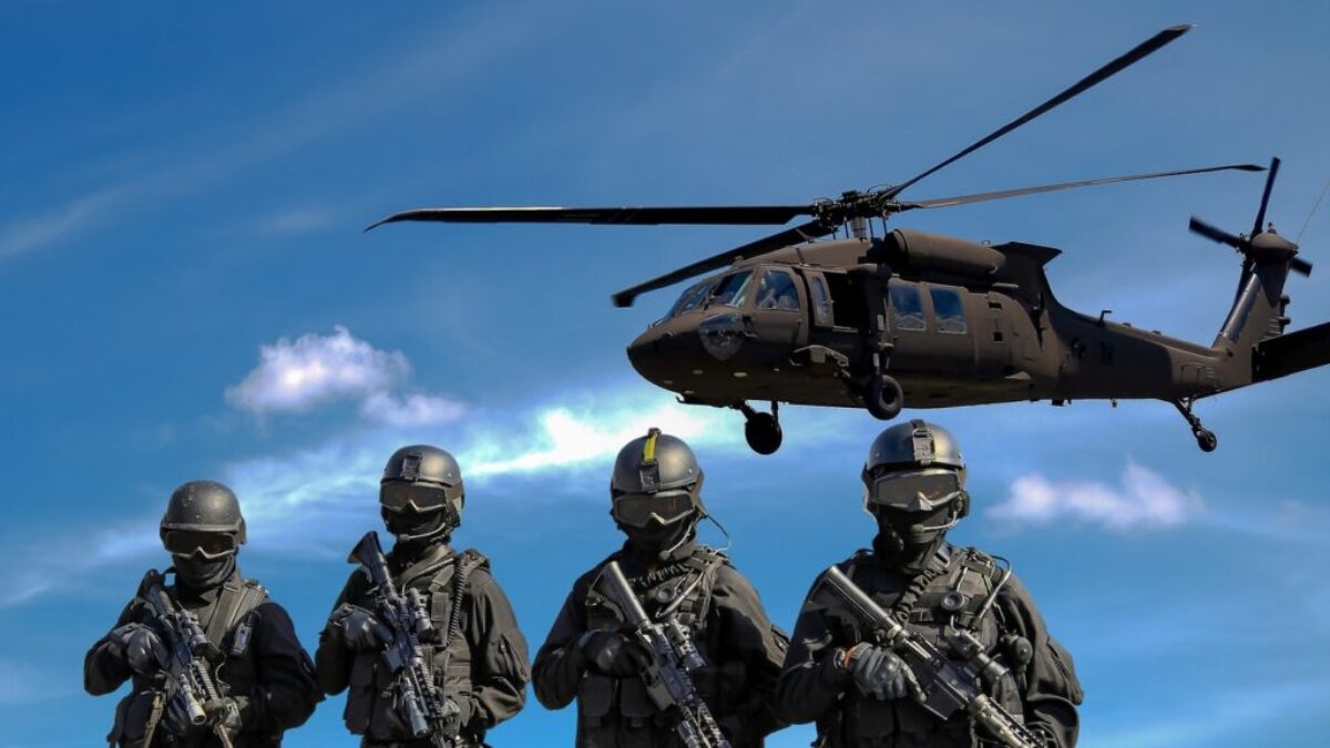 Four Soldiers Carrying Rifles Near Helicopter Under Blue Sky