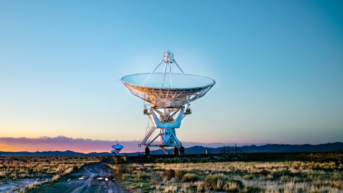 white radar telescope on grass field