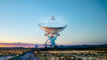 white radar telescope on grass field