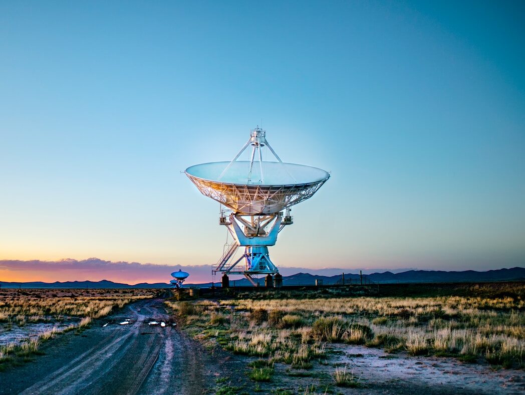 white radar telescope on grass field