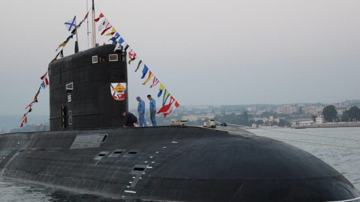 black ship on sea under gray sky during daytime