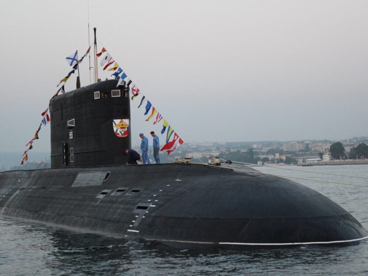 black ship on sea under gray sky during daytime