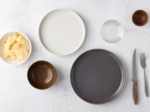 white ceramic round plate beside clear drinking glass
