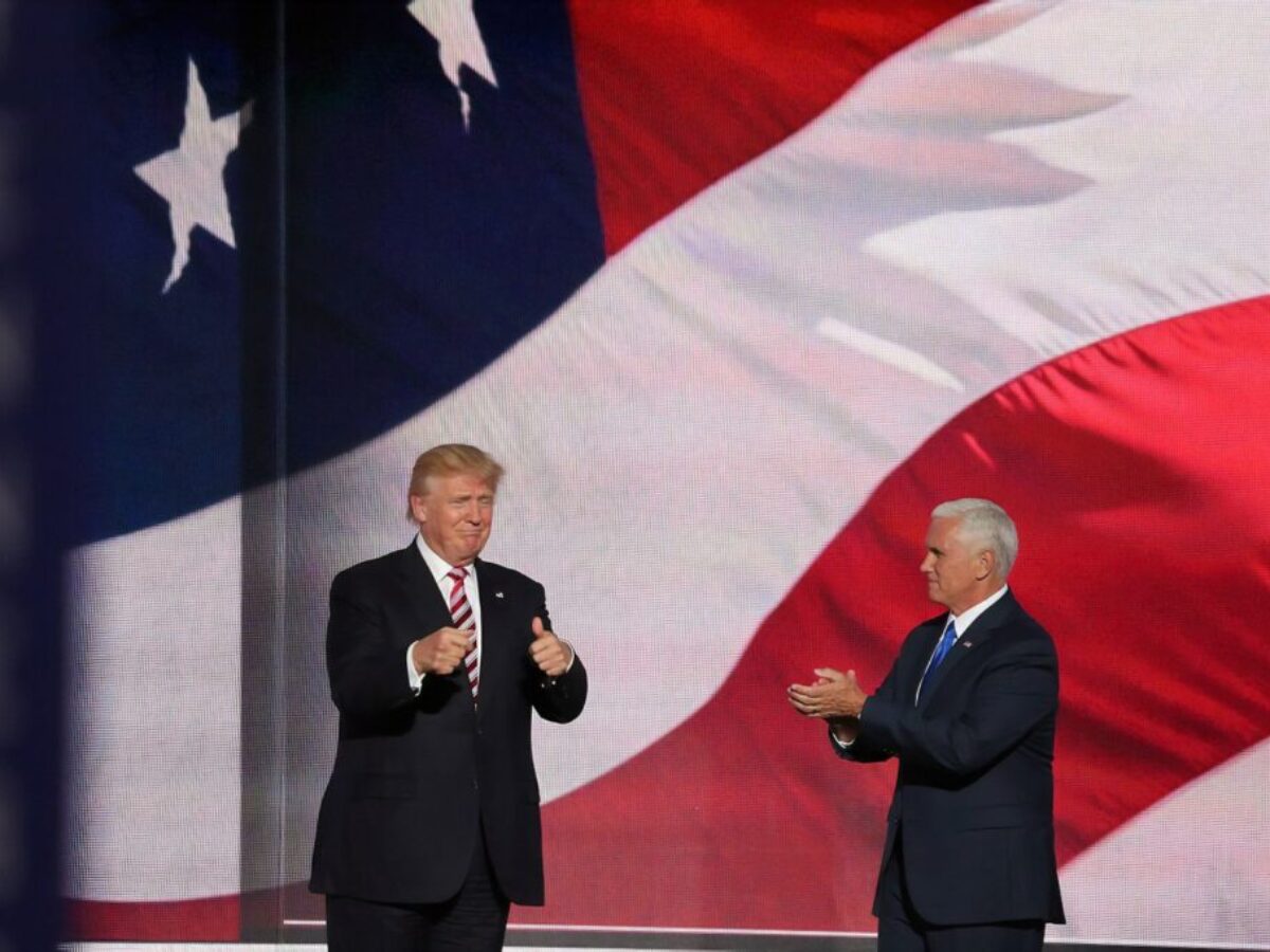 Donald Trump beside man in black suit